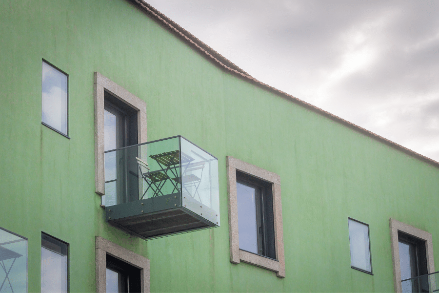 glass balcony view on a green building