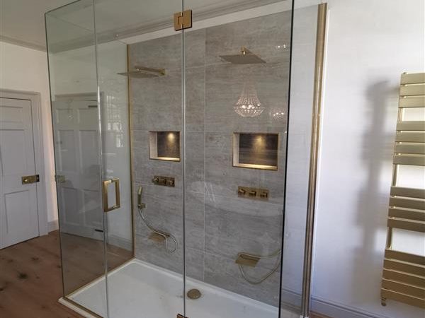 gold and glass shower enclosure